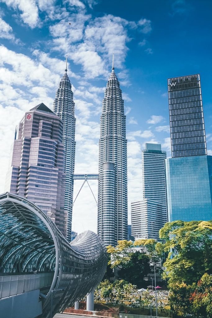 Stunning view of the iconic Petronas Towers and surrounding skyscrapers in Kuala Lumpur during the day.